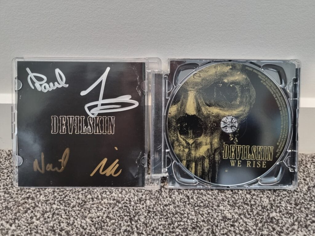 My signed CD of Devilskin We Rise