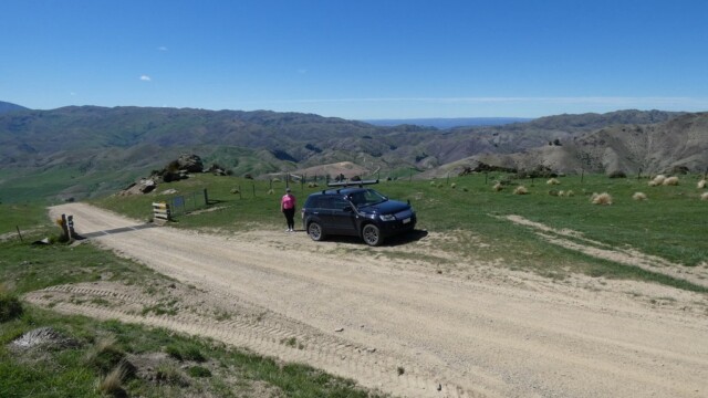 Parked up for a look around Jenna and the Suzuki parked past a cattle stop with the hills in the background