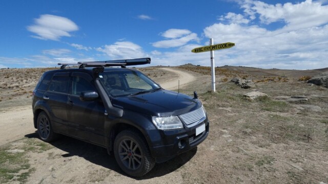 Parked up with a "Road Sign" The Suzuki Escudo parked at the sign pointing towards Nevis Valley Base Camp (17km) and to Mt Cook (198km)