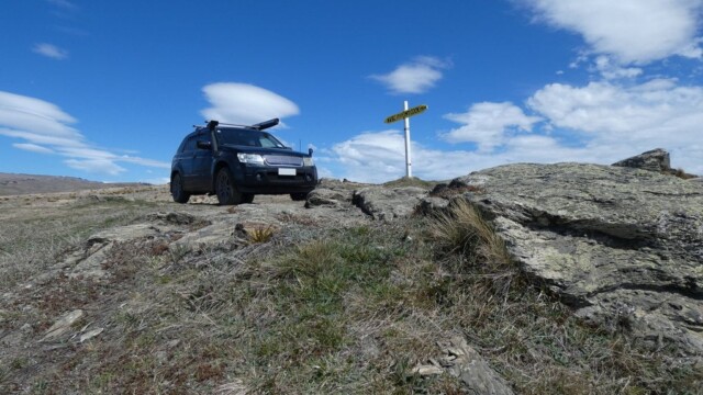 Parked up for an arty shot by the NVBC and Mt Cook road sign The Suzuki Escudo at the NVBC and Mt Cook Cook road sign with some rocks in the foreground and some scaterred cloud in the back ground