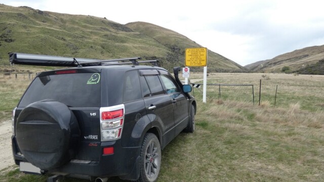 Parked at the Southland boundary with the warning sign of the winter road closures. The Suzuki Escudo parked at at eh Southland boundary with the road sign warning of the road being closed over winter