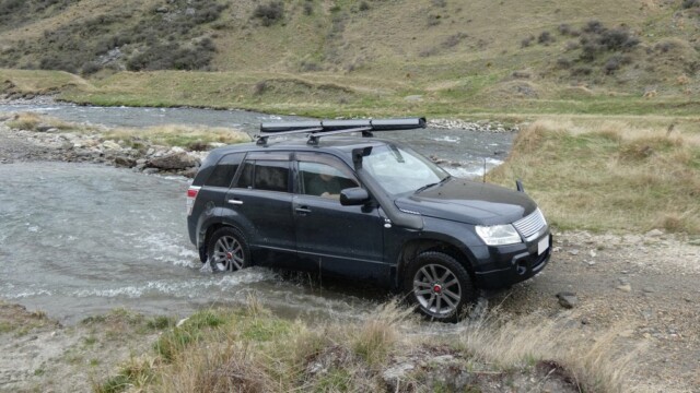 Climbing out of the river crossing The Suzuki Escudo climbing out of the river crossing with the other river and hills in the background
