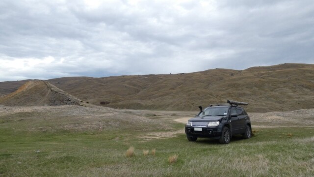 The Suzuki parked up near some gold mining sleuths. Parked on the grasslands and near some gold mining sleuths.