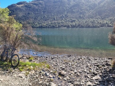 The water of Loch Katrine is so clear and just awesome My moutnain bike up against a tree beside Loch Katrine with a bushy hill on the other side