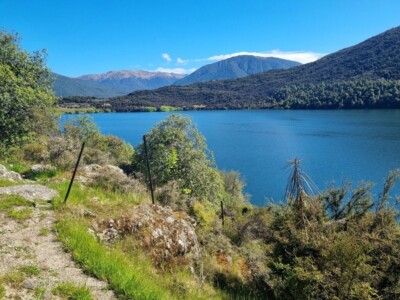 Such vivid colours over Loch Katrine At the top of a rise looking down over Loch Katrine. Bright green contrasting the blue of the watrer and sky