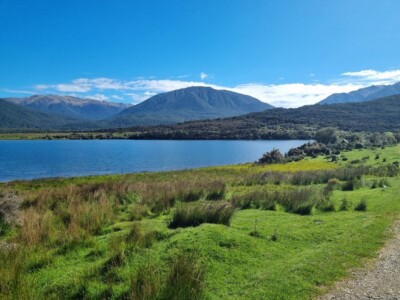 Loch Katrine as it opens up with the grassy fields around it. Near the top of Loch Katrine it opens up to grassy fields