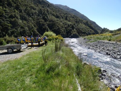 A group of white water rafters having a briefing beside the Hurunui River. A group of white water rafters having a briefing beside the Hurunui River. They are all dressed up ready for the trip with the raft in the middle