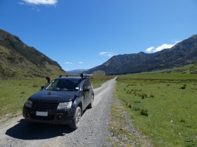 Heading out on Lake Sumner Road. My Escudo on the straight gravel road flanked by grasslands and mountains on the side.